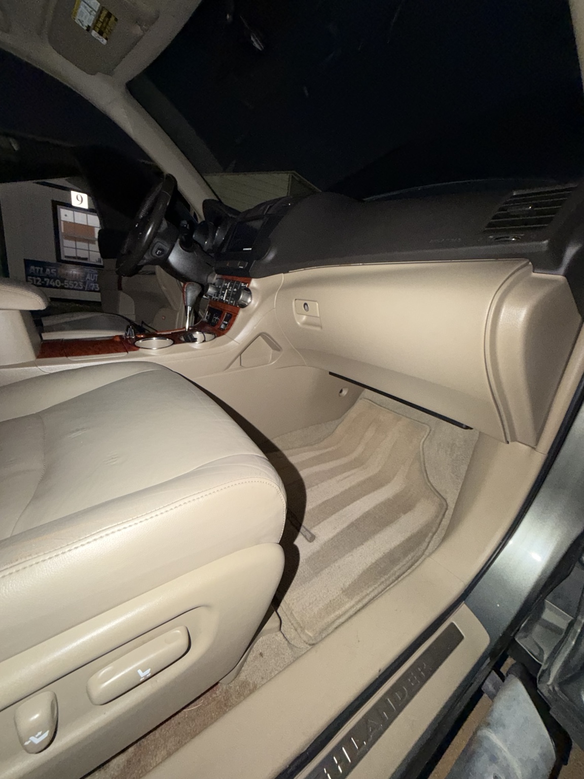 Clean beige front seats, dashboard, and floor mats